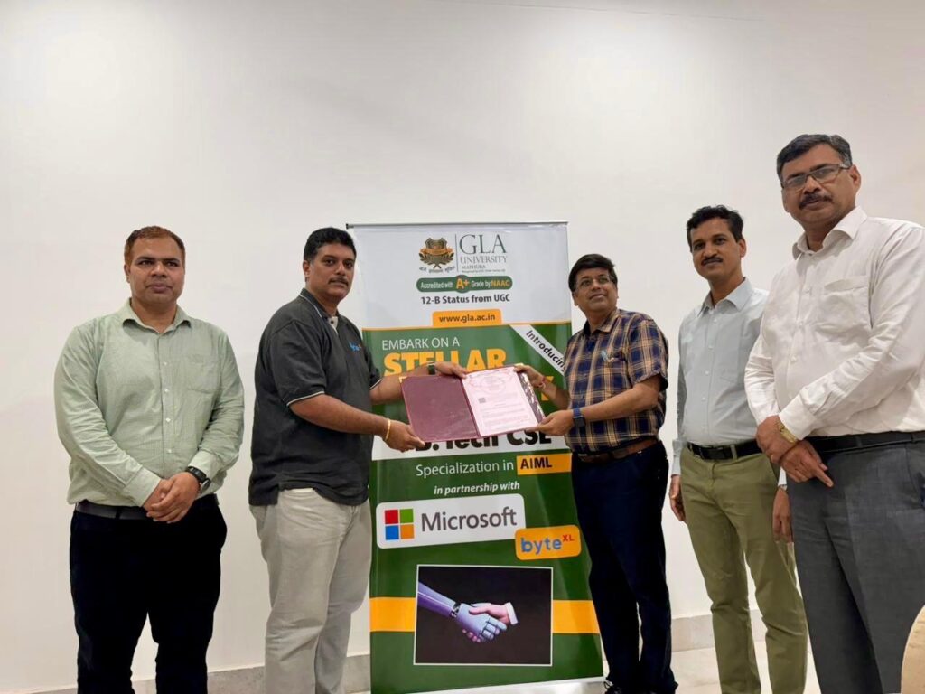 GLA university registrar Ashok Kumar Singh signing agreement with bytexl co-founder Karun Tadepalli to offer B.Tech program in AI & ML at the university