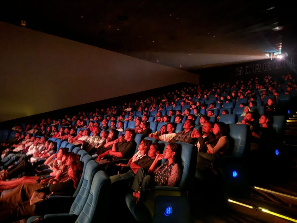 People enjoying movie in cinema theatre - 1.